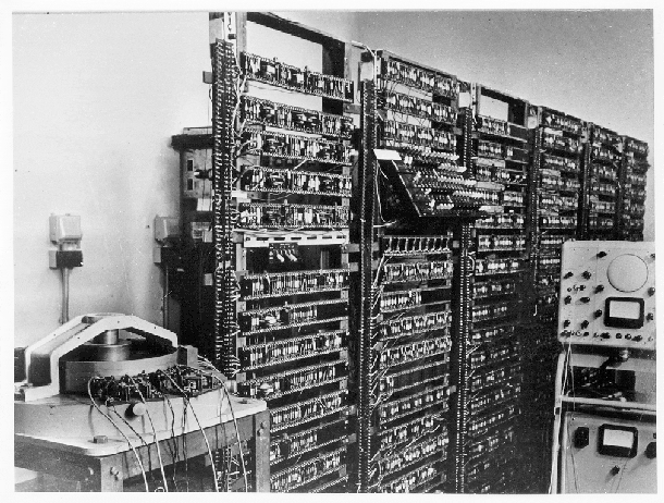 <strong>When Was it Promised:</strong> Quantum computing was first proposed in the mid-1980's by none other than everyone's favorite bongo-playing, drug-taking, safe-cracking, strip-club-patronizing, Nobel Prize-winning physicist Richard Feynman. The idea came out of speculation about shrinking transistor size. With transistor size shrinking by half every year, physicists predicted that transistors would get down to the size of single atoms by the year 2020. Feynman predicted that when that happened, computers would be subject to the strange laws of quantum mechanics, and could use them, probably, to solve complex math problems. <strong>What's the Holdup:</strong> In the late 1980's and early 1990's quantum computing fell into a aso what?a category. There was no progress because no one could think of any uses for it. Then, in 1994, Peter Shore at AT&amp;T came up with the killer app for quantum computers. He proved that quantum computers would be very good at factoring numbers down to their prime number constituents. And since factoring prime numbers is the basis of most modern computer security, a quantum computer could be the ultimate code breaker. Needless to say, people got interested. Since then, the focus has been overcoming engineering challenges like keeping the quantum particles isolated enough from the outside world to hold multiple quantum states. aIt's not like going from a Pentium II to a Pentium III,a said Raymond Laflamme, director of the Institute for Quantum Computing, ait's a very different way of looking at how information is handled.a <strong>When Can I Get One:</strong> Said Laflamme, aWhen people do predictions on the scale of 20 or 30 years, 20 or 30 years later others always look back and laugh at them. I think it will take 20 years to really understand the system. But you had asked me 10 years ago, I would have said 50 or 100 years.a So I guess we're at least moving in the right direction. <em>[At left: The first transistor computer. This prototype was operational in 1953.]</em>