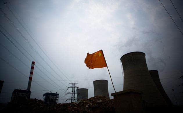 A Chinese flag flies in front of a coal-fired power plant in Tianjin, China. China is the world's biggest user of coal, and the world's biggest emitter of carbon. (c) Jeff Hutchens/Getty Images