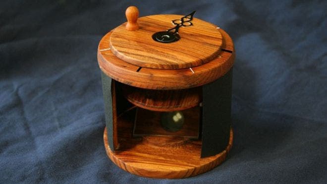 A Viking sunstone compass from a calcite crystal, used in the experimental setup by Rennes researchers. The two beams of light can be seen on the reflective surface inside. (c) Guy Ropars, University of Rennes 