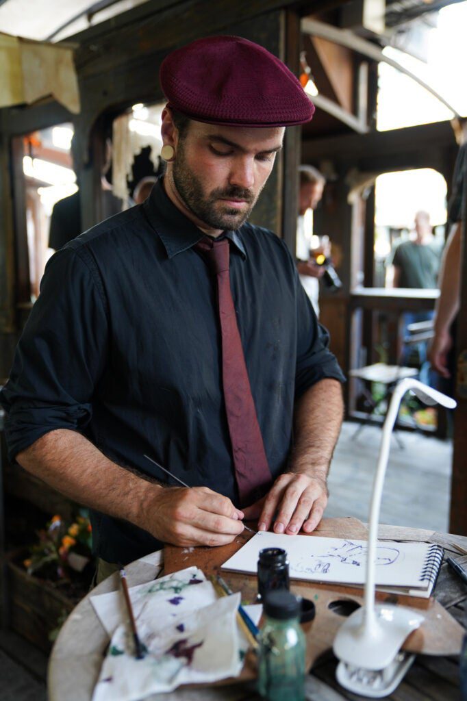 man drawing on sketchpad