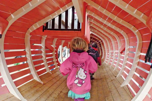 Inside the wood-slatted belly of a whale.