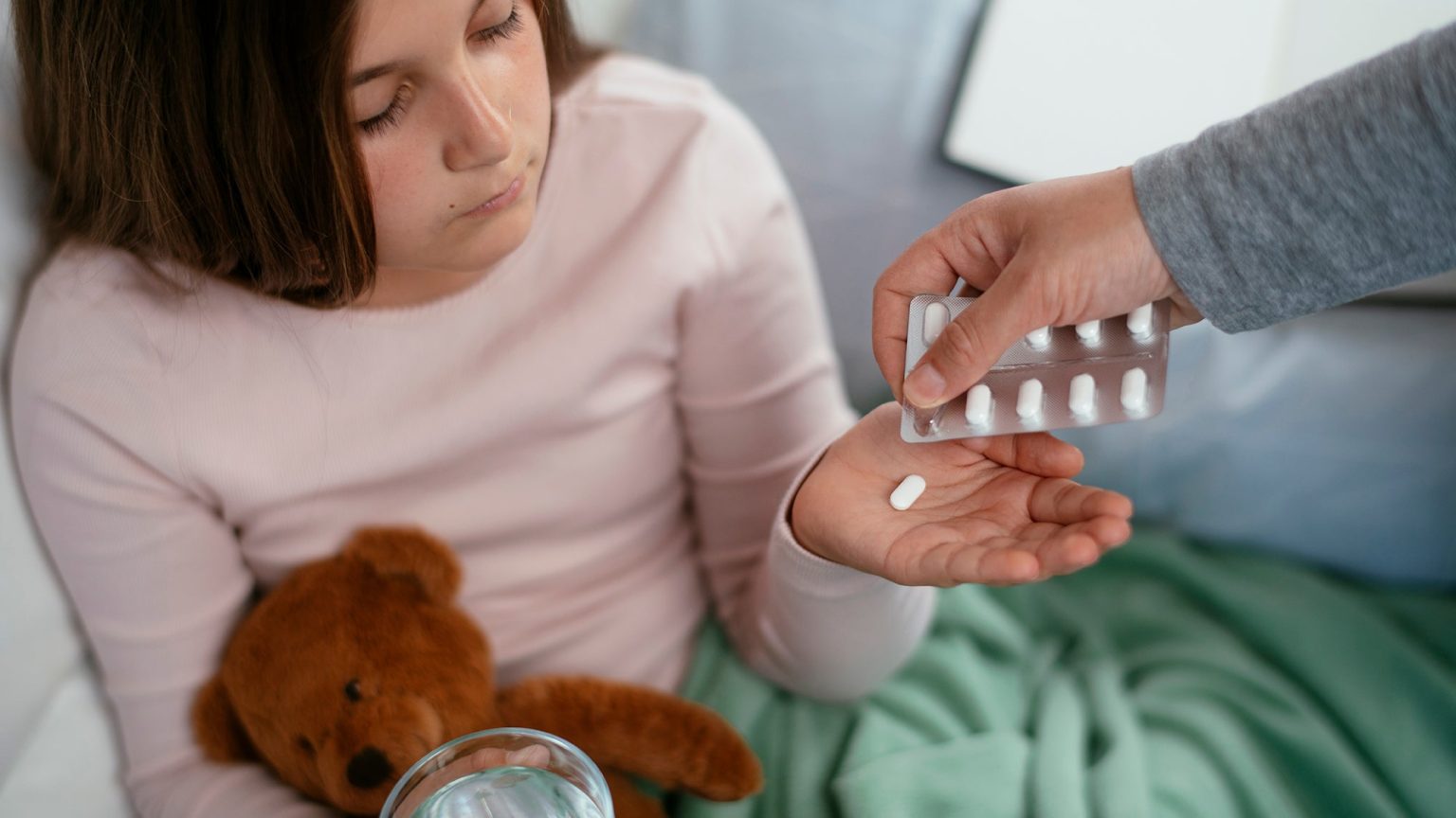 – 20240308child getting medicine from parent