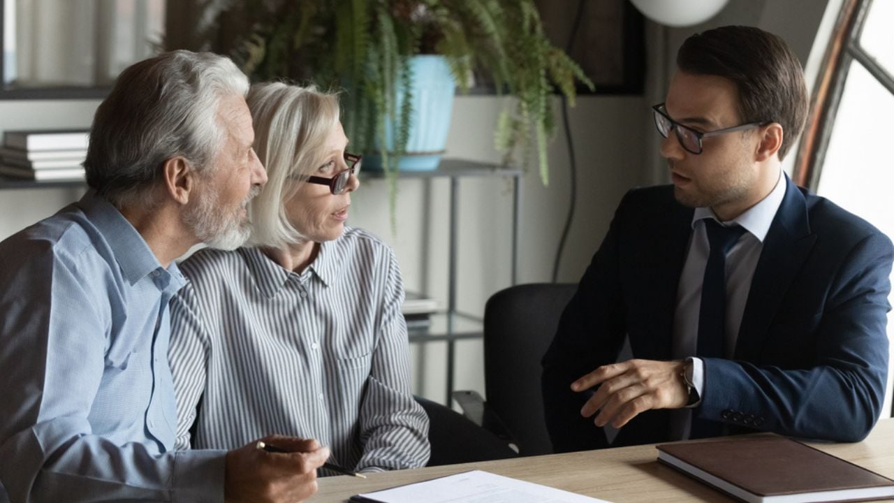 Male bank specialist worker consult mature man and woman spouses about elderly health insurance. Middle-aged Caucasian couple clients customers have meeting with real estate agent or broker.