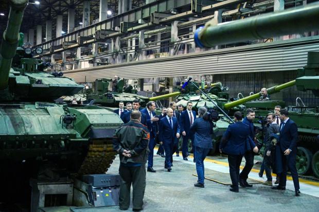 FILE - Russian President Vladimir Putin, center, visits the Uralvagonzavod factory in Nizhny Tagil, Russia, on Thursday, Feb. 15, 2024. Military industries have become a key engine of Russia's economic growth, with defense plants churning out missiles, tanks and ammunition. (Ramil Sitdikov, Sputnik, Kremlin Pool Photo via AP, File)