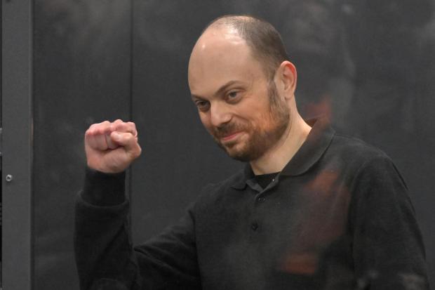 FILE - Russian opposition activist Vladimir Kara-Murza gestures while standing in a defendants' cage at the Moscow City Court in Moscow, Russia, on July 31, 2023. Kara-Murza, 42, was convicted of treason for publicly denouncing the war in Ukraine and sentenced to 25 years in prison earlier this year. (AP Photo, File)