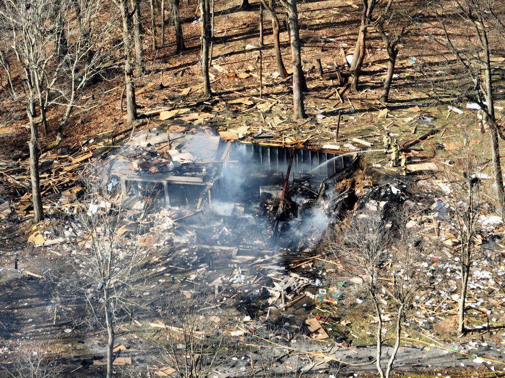 Debris remains after a house explosion on Tuesday, March 12, 2024 in Crescent Township, Pa. Allegheny County emergency dispatchers said the blast in Crescent Township in the northwest Pittsburgh suburbs was reported at about 9 a.m. Tuesday. Police, fire and emergency services were dispatched to the scene, dispatchers said. (Tim Robbibaro/Pittsburgh Post-Gazette via AP)