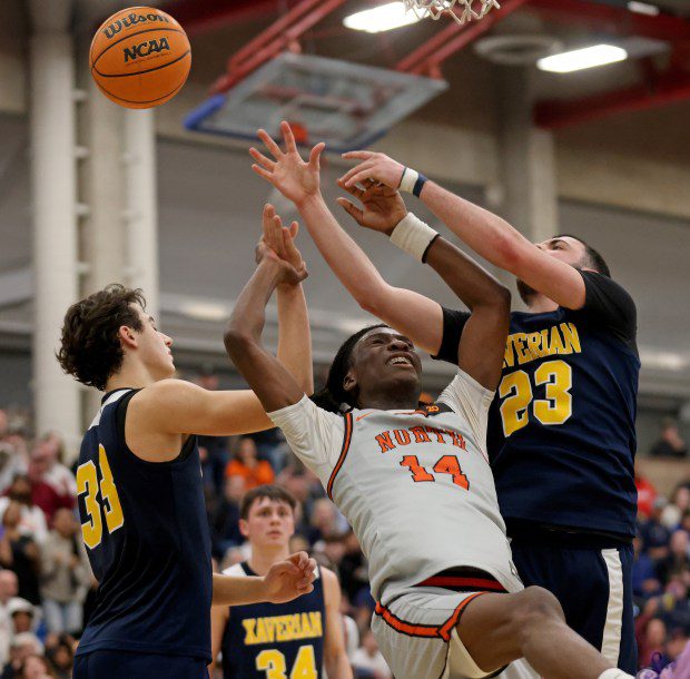 North High's Teshuan Steele, center, gets tangled up with Xaverian's Lorenzo Carrara, left, and Roman Perdoni at UMass Boston on Wednesday. (Matt Stone/Boston Herald)