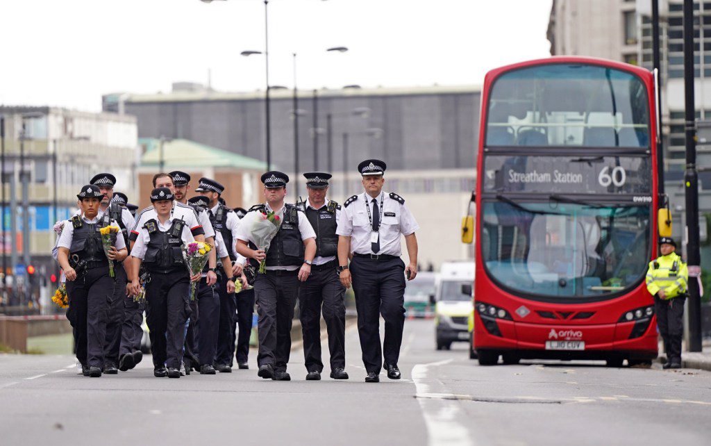 Police officers arrive to lay flowers at the scene in Croydon, south London, where 15-year-old Elianne Andam was stabbed to death on Wednesday morning. Picture date: Thursday September 28, 2023. PA Photo. A 17-year-old boy, who knew the victim, was arrested just over an hour after the attack which took place on busy Wellesley Road at around 8.30am. See PA story POLICE Croydon. Photo credit should read: James Manning/PA Wire