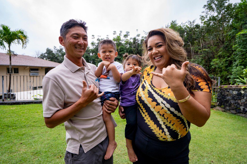 From left to right, Cody Matsuda, KihaaPi'ilani Makainai-Matsuda, Keli'inowelo Makainai-Matsuda and Mailani Makainai flash a shaka during a photo shoot on Wednesday, March 6, 2024, in Kaneohe, Hawaii. (AP Photo/Mengshin Lin)