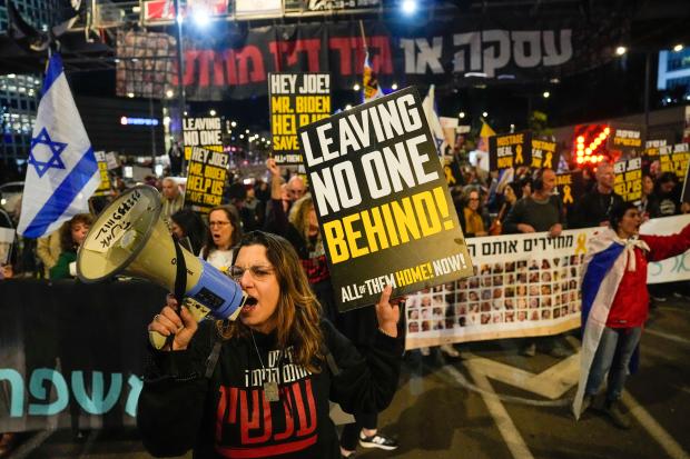 Friends and relatives of the Israeli hostages held in the Gaza Strip by Hamas attend a rally calling for their release, in Tel Aviv, Israel, Saturday, March 9, 2024. With each passing day, the relatives of hostages in Gaza face a deepening despair. (AP Photo/Ariel Schalit)