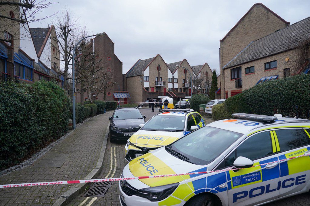 Police officers at the scene near Bywater Place in Surrey Quays, south east London, where a man has died after being shot by armed police responding to calls for help in the early hours of this morning. A man aged in his 30s who was reportedly armed with a crossbow trying to force his way into a building in Bywater Place just before 5am on Tuesday and was threatening to hurt the people inside. Picture date: Tuesday January 30, 2024. PA Photo. See PA story POLICE Southwark. Photo credit should read: Lucy North/PA Wire