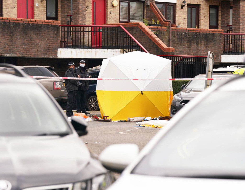 Police officers at the scene near Bywater Place in Surrey Quays, south east London, where a man has died after being shot by armed police responding to calls for help in the early hours of this morning. A man aged in his 30s who was reportedly armed with a crossbow trying to force his way into a building in Bywater Place just before 5am on Tuesday and was threatening to hurt the people inside. Picture date: Tuesday January 30, 2024. PA Photo. See PA story POLICE Southwark. Photo credit should read: Lucy North/PA Wire