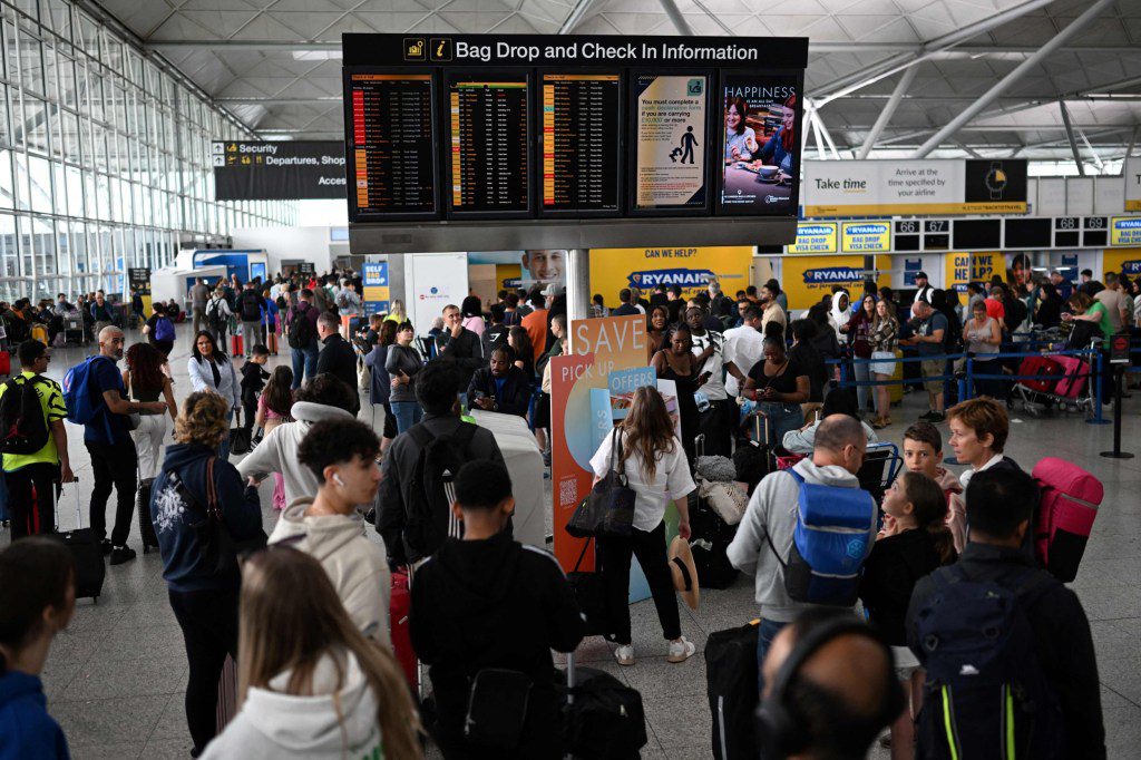 Passengers wait at Stansted Airport, north of London, on August 29, 2023 after UK flights were delayed over a technical issue. Flights to and from the UK were experiencing disruptions after Britain's air traffic control systems were temporarily hit by a technical fault. The National Air Traffic Services (NATS) said it had 