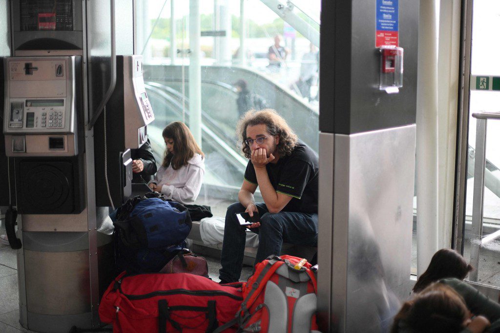 Passengers wait at Stansted Airport, north of London, on August 29, 2023 after UK flights were delayed over a technical issue. Flights to and from the UK were experiencing disruptions after Britain's air traffic control systems were temporarily hit by a technical fault. The National Air Traffic Services (NATS) said it had 