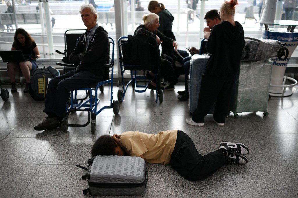 Passengers wait at Stansted Airport, north of London, on August 29, 2023 after UK flights were delayed over a technical issue. Flights to and from the UK were experiencing disruptions after Britain's air traffic control systems were temporarily hit by a technical fault. The National Air Traffic Services (NATS) said it had 