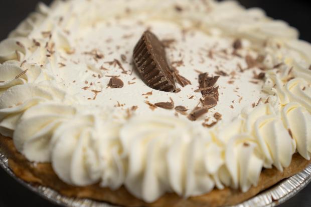 A freshly decorated chocolate peanut butter pie rests on a counter at Michele's Pies, Wednesday, March 13, 2024, in Norwalk, Conn. Math enthusiasts and bakers celebrate Pi Day on March 14 or 3/14, the first three digits of a mathematical constant with many practical uses. Around the world many people will mark the day with a slice of sweet or savory pie. (AP Photo/John Minchillo)