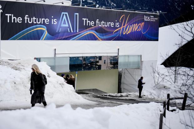 FILE - An advertising banner with a slogan about AI is fixed at a building at the Davos Promenade, alongside the World Economic Forum in Davos, Switzerland, Jan. 18, 2024. Artificial intelligence is supercharging the threat of election disinformation worldwide, making it easy for anyone to create fake, but convincing, content aimed at fooling voters. A wave of AI deepfakes tied to elections in Europe and Asia has coursed through social media for months, serving as a warning for more than 50 countries heading to the polls this year. (AP Photo/Markus Schreiber, File)