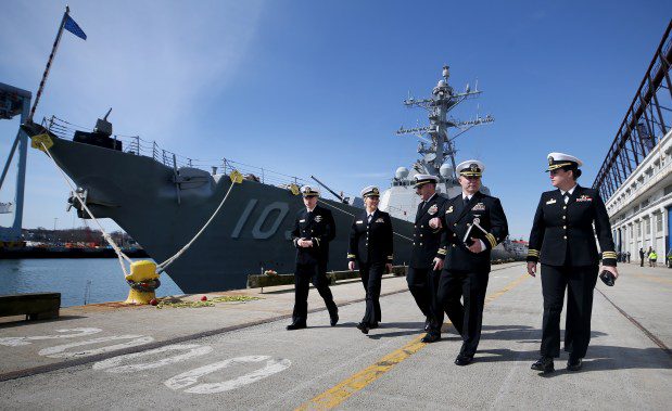 ENS Andrew Loder, Lt. Meghan Brooks, Lt. Cmdr David Carter, CDR Chance Smith, Truxton Commanding Officer and Cmdr Billie Farrell, of the USS Constitution, walk past the destroyer USS Truxton after docking at Black Falcon terminal. (Nancy Lane/Boston Herald)