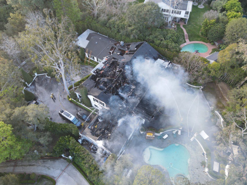 Cara Delevingne's massive Los Angeles house catches fire. Firefighters can be seen working to put out the fire.