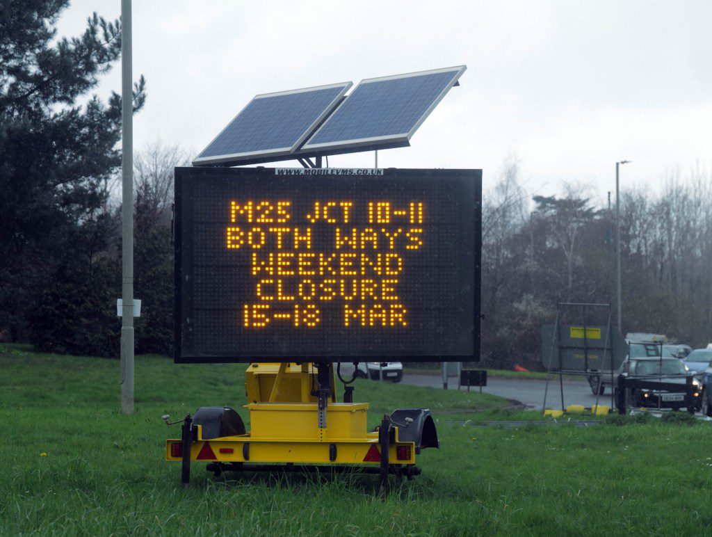 A sign on the road side detailing a closure on the M25.