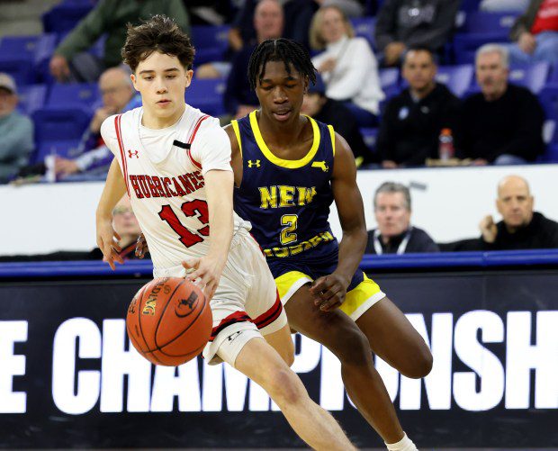 Hoosac Valley's Trevor Moynihan dribbles in front of New Mission's Musa Fofana during the Div. 5 boys basketball state title in Lowell. (Photo by Mark Stockwell/Boston Herald)