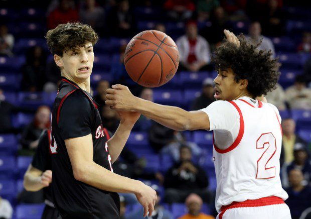 Old Rochester's Gavin Martin, left, and Charlestown's Jordany Mak eye a loose ball during Saturday's state championship game at the Tsongas Center. (Photo by Mark Stockwell/Boston Herald)