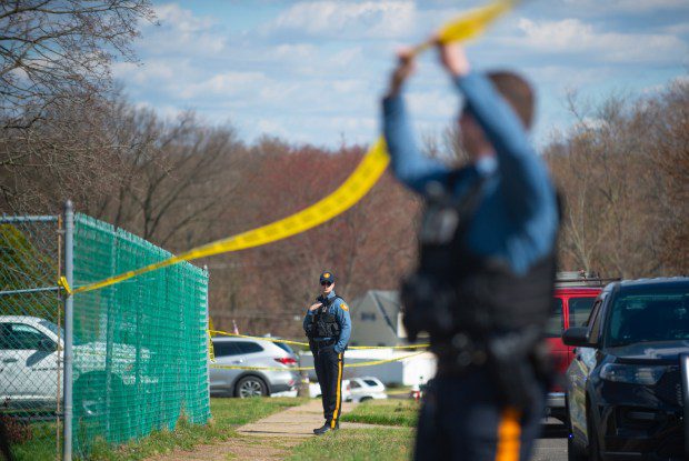 Police officers from the Falls Township Police Department tape off and inspect the scene of a shooting in the Vermillion Hills neighborhood March 16, 2024, in the Levittown section of the township. Andre Gordon shot and killed three people before fleeing to Trenton, police said. (Matthew Hatcher/Getty Images)