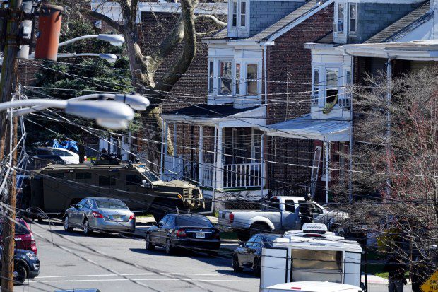 Police surround a home in Trenton, N.J. on Saturday, March 16, 2024. A suspect has barricaded himself in the home after allegedly shooting three people to death in suburban Philadelphia on Saturday, authorities said. (Matt Rourke/AP)