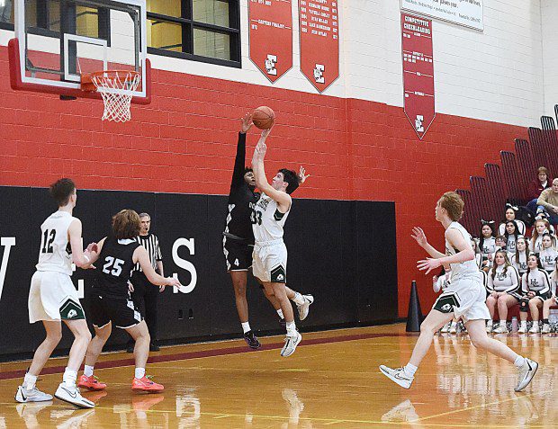 Dock Mennonite's Ethan Parr, 4, blocks a shot by Holy Cross's Mario Matrone in the PIAA-2A quarterfinals at Easton Area Middle School on Saturday, March 16, 2024. (MediaNews Group)