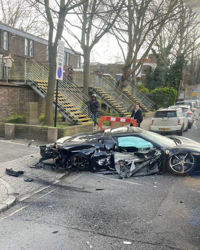 Shocking photos show the aftermath of a crash that wrecked a quarter-of-a-million-pound Ferrari. Release date ? March 17, 2024. The black supercar was one of two cars involved in the crash in Islington, north London, which saw one of its wheels detached and flung to the opposite side of the road. Photos shared by onlookers show the crumpled car, a Ferrari 296 GTB, with its boot open and missing a wheel, with twisted metal strewn across the road. The vehicle can reach speeds of 62 miles per hours in 2.9 seconds. The crash, which occurred at around 1pm, caused the road to be shut for some time, with buses and cars unable to move. An air ambulance attended the scene and one man was treated at the scene before being rushed to hospital. His injuries are not believed to be life-threatening.