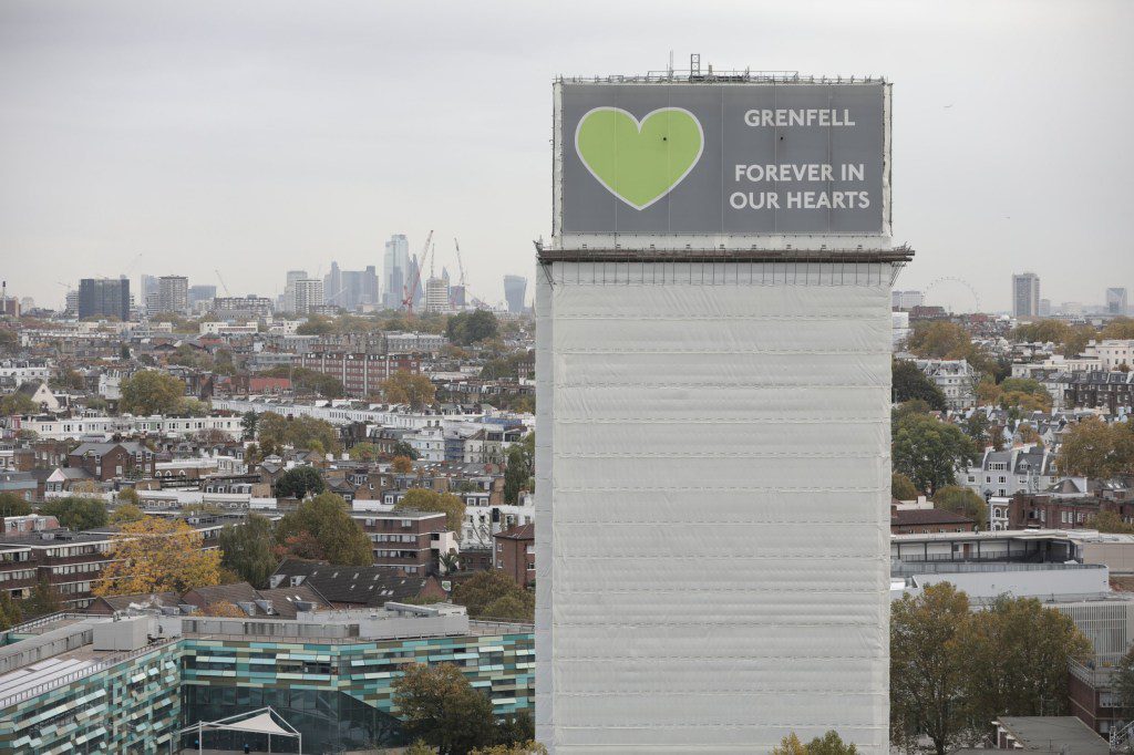 A general view of what remains of Grenfell Tower covered with hoardings following a severe fire in June 2017