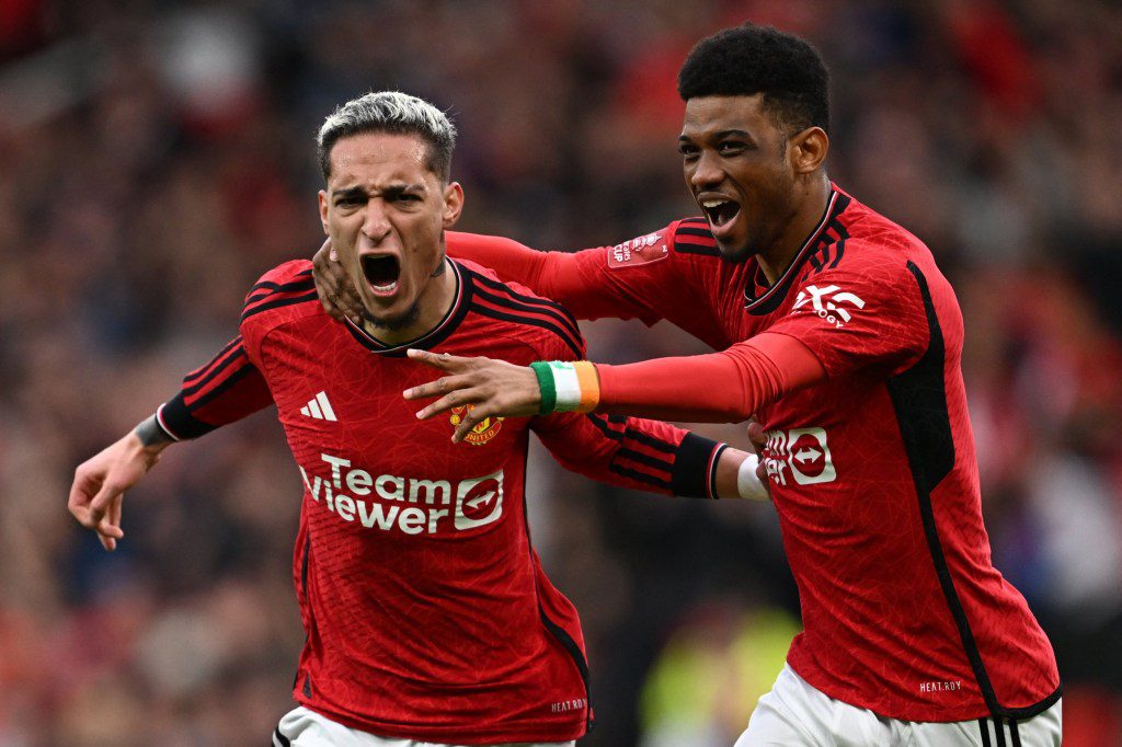 Manchester United's Brazilian midfielder #21 Antony (L) celebrates with Manchester United's Ivorian midfielder #16 Amad Diallo (R) after scoring their second goal during the English FA Cup Quarter Final football match between Manchester United and Liverpool at Old Trafford in Manchester, north west England, on March 17, 2024. (Photo by Paul ELLIS / AFP) / RESTRICTED TO EDITORIAL USE. No use with unauthorized audio, video, data, fixture lists, club/league logos or 'live' services. Online in-match use limited to 120 images. An additional 40 images may be used in extra time. No video emulation. Social media in-match use limited to 120 images. An additional 40 images may be used in extra time. No use in betting publications, games or single club/league/player publications. / (Photo by PAUL ELLIS/AFP via Getty Images)