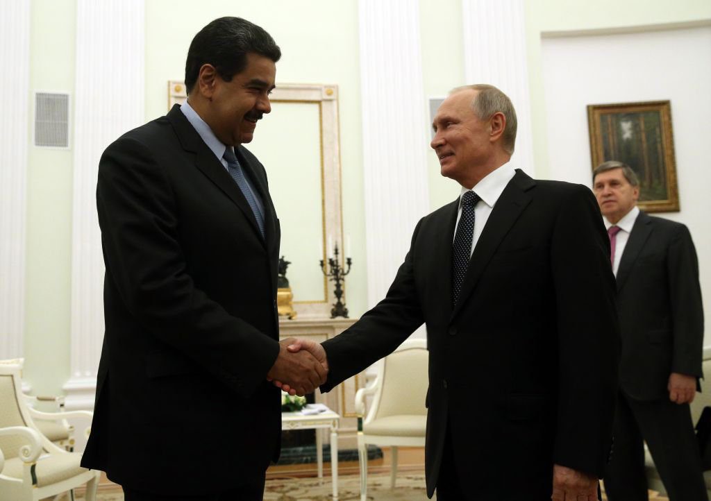 Russian President Vladimir Putin (R) greets Venezuela's President Nicolas Maduro