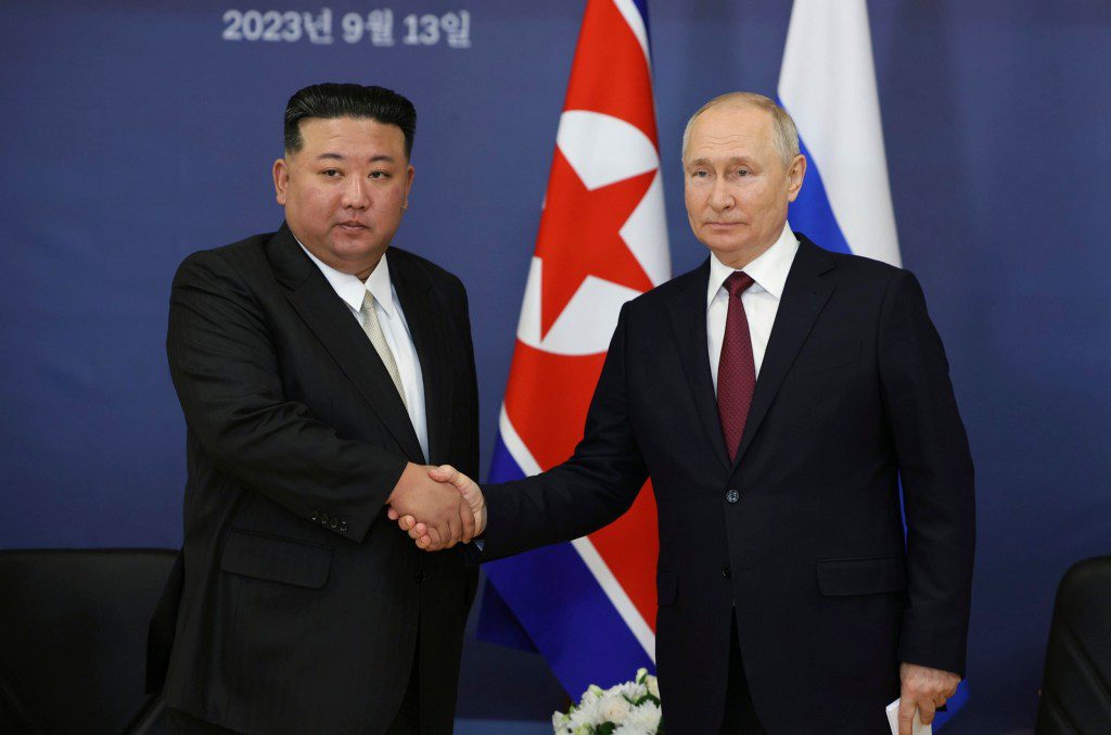 Russian President Vladimir Putin, right, and North Korean leader Kim Jong Un shake hands