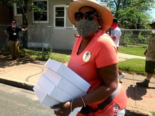 Rose McGee carries four boxes of pie.