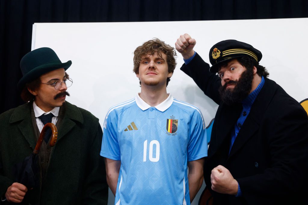 A model presents the Belgian football team's new away jersey paying tribute to Belgian comics series character Tintin surrounded by characters of Professor Sunflower and Capitain Hadock