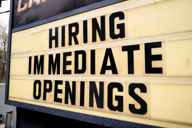 In this file photo, a hiring sign is posted outside business in Huntingdon Valley, Pa., Tuesday, Feb. 22, 2022. (AP Photo/Matt Rourke FILE)