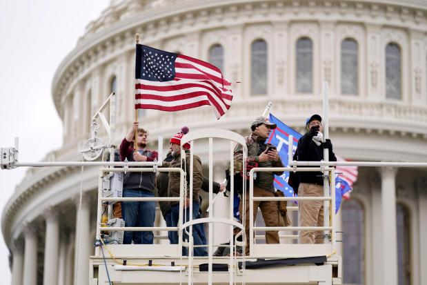 FILE - Supporters of President Donald Trump riot at the Capitol in Washington, on Jan. 6, 2021. Trump is making the Jan. 6, 2021 attack on the Capitol a cornerstone of his bid to return to the White House. Trump opened his first rally as the presumed Republican Party presidential nominee standing in salute with a recorded chorus of Jan. 6 prisoners singing the national anthem. (AP Photo/Julio Cortez, File)