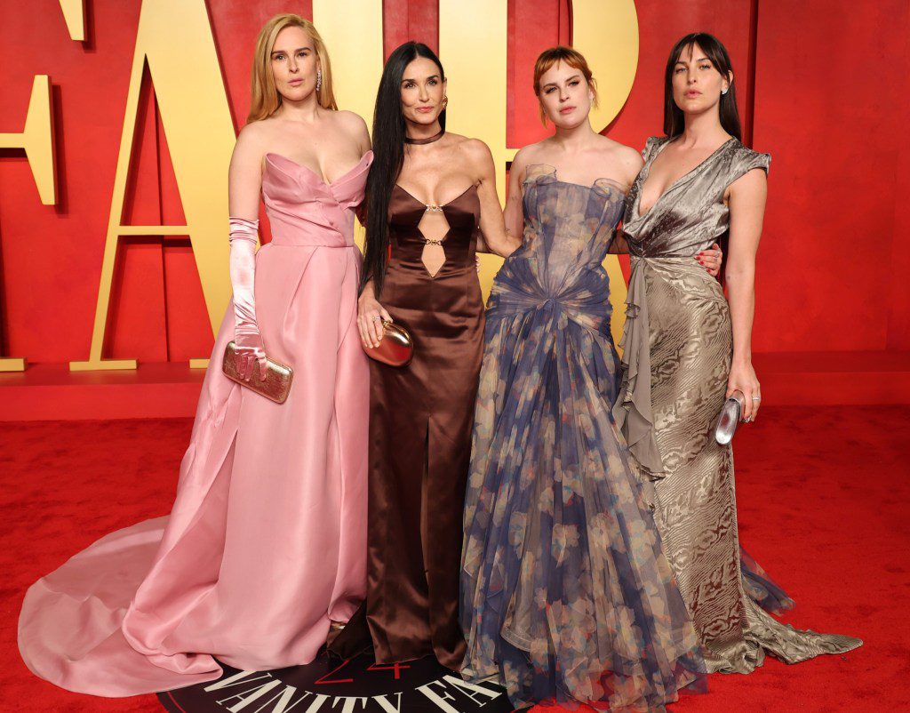 Rumer Willis, Demi Moore, Tallulah Willis, and Scout LaRue Willis on the red carpet in floor length dresses