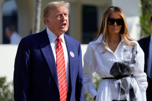 Republican presidential candidate former President Donald Trump talks as former first lady Melania Trump listens as they leave after voting in the Florida primary election in Palm Beach, Fla., yesterday.