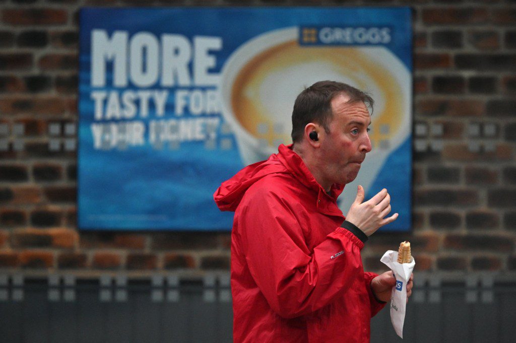 A customer carries take-away purchase after leaving a Greggs bakery in central London on March 5, 2024. British bakery Greggs, famed for its sausage rolls, said Tuesday it logged soaring profit last year, as consumers flocked to the budget chain during a cost-of-living crisis. Net profit leapt almost a fifth to ??142.5 million ($180.6 million) from 2022, Greggs said in a results statement, adding that revenue soared by a similar proportion to ??1.8 billion. (Photo by JUSTIN TALLIS / AFP) (Photo by JUSTIN TALLIS/AFP via Getty Images)