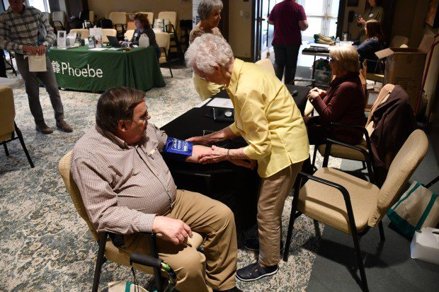 Resident George Beichler has his blood pressure taken by retired nurse June Etchberger. (Courtesy of Phoebe Berks)