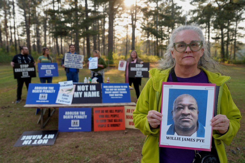 Cathy Harmon-Christian, the executive director of 'Georgians for Alternatives to the Death Penalty', holds a photo of Willie James Pye outside of the Georgia Diagnostic Prison in Jackson, Georgia, U.S. March 20, 2024. REUTERS/Jayla Whitfield-Anderson