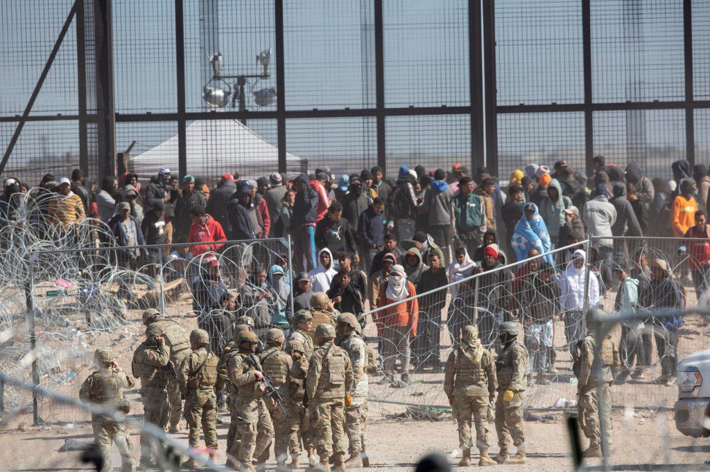 Migrants who breached the barriers set up on the Rio Grande in El Paso, Texas by Texas National Guard on Thursday, March 21, 2024. The migrants were hoping to be processed by Border Patrol. (Omar Ornelas/El Paso Times via AP)