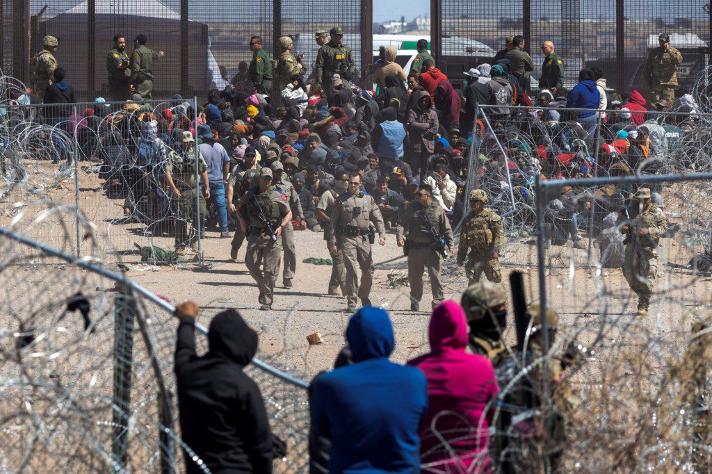 Texas State Troopers walk towards a fence after migrants broke through razor wire to enter the U.S., as SB 4 law that would empower law enforcement authorities in the state to arrest people suspected of illegally crossing the U.S.-Mexico border was temporarily blocked, as seen from Ciudad Juarez, Mexico, March 21, 2024. REUTERS/David Peinado