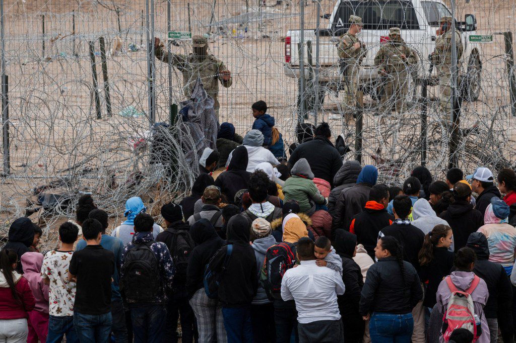 Migrants plead with the Texas National Guard to be let through concertina wire on the U.S. side of the Rio Grande on the day the U.S. 5th Circuit Court of Appeals hears oral arguments on Texas' motion to lift a block on its SB4 immigration law that would allow state officials to arrest migrants suspected of being in the country illegally, in El Paso, Texas, U.S., as seen from Ciudad Juarez, Mexico March 20, 2024. REUTERS/Justin Hamel TPX IMAGES OF THE DAY