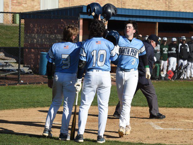 North Penn's Chase Jones, 2, is congratulated by Kevin Brace, 3, and Josh Martinell, 10, after Jones' two-run home run in the bottom of the third inning against Pennridge during their game on Thursday, March 21, 2024. (Mike Cabrey/MediaNews Group)