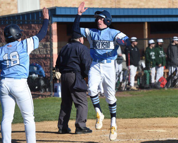 North Penn's Jeremiah Criger, 14, goes to give Mason Coyne, 18, a high five after Criger scored a run in the bottom of the fourth inning against Pennridge during their game on Thursday, March 21, 2024. (Mike Cabrey/MediaNews Group)