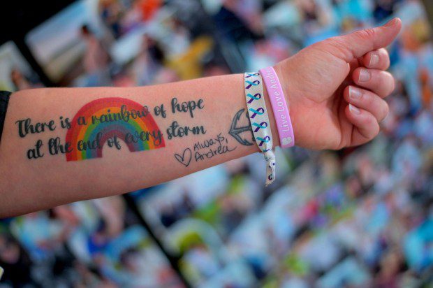 Kyra Vocci has a tattoo on her forearm that reads, "There is a rainbow of hope at the end of every storm; Always, Andrea" with the closing in the handwriting of her late sister Andrea Kolbe, who took her own life in December while fighting postpartum depression. (Karl Merton Ferron/Staff)