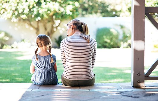 Mother and children speaking outside.